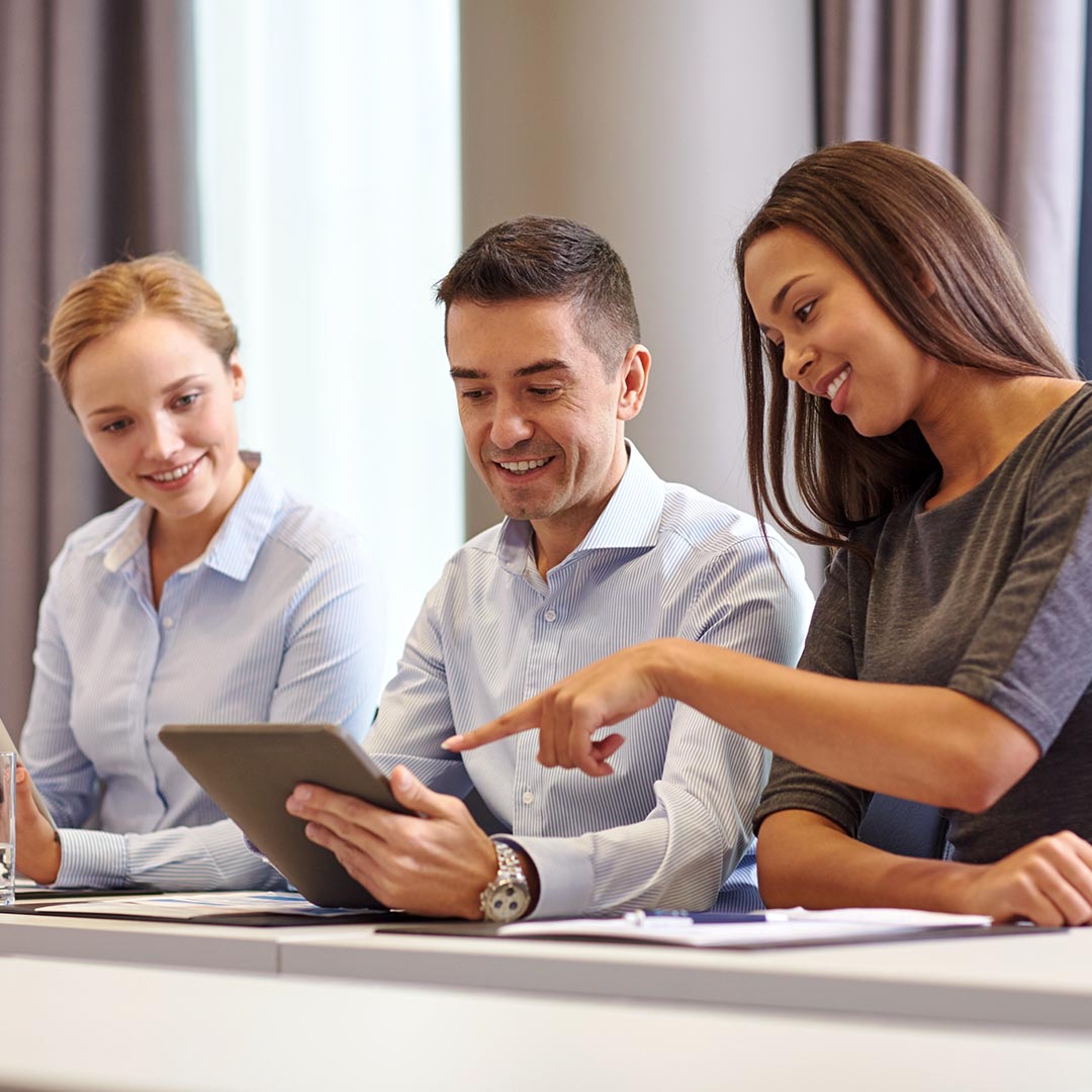 Smiling business associates using a tablet